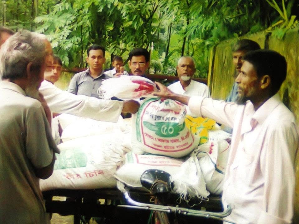 Villagers receiving sacks of rice