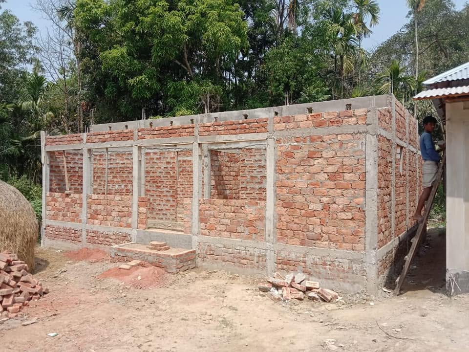A new brick house under construction in a Bangladeshi village